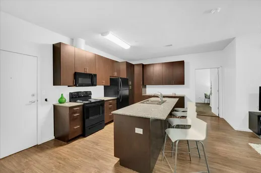 Modern kitchen with dark cabinetry.