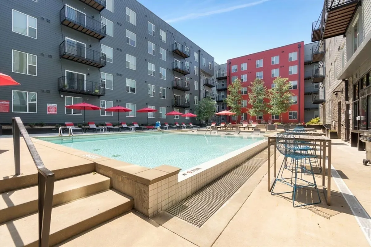 Modern apartment pool area with umbrellas