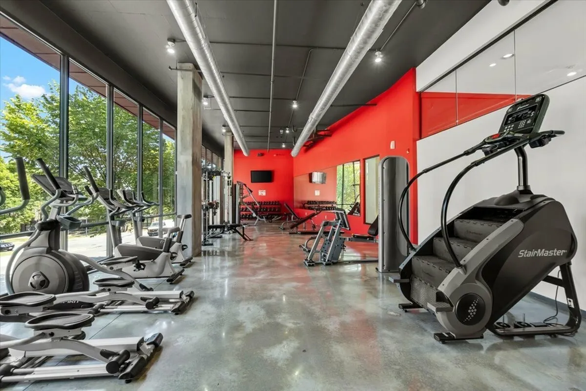 Modern gym with various exercise equipment.